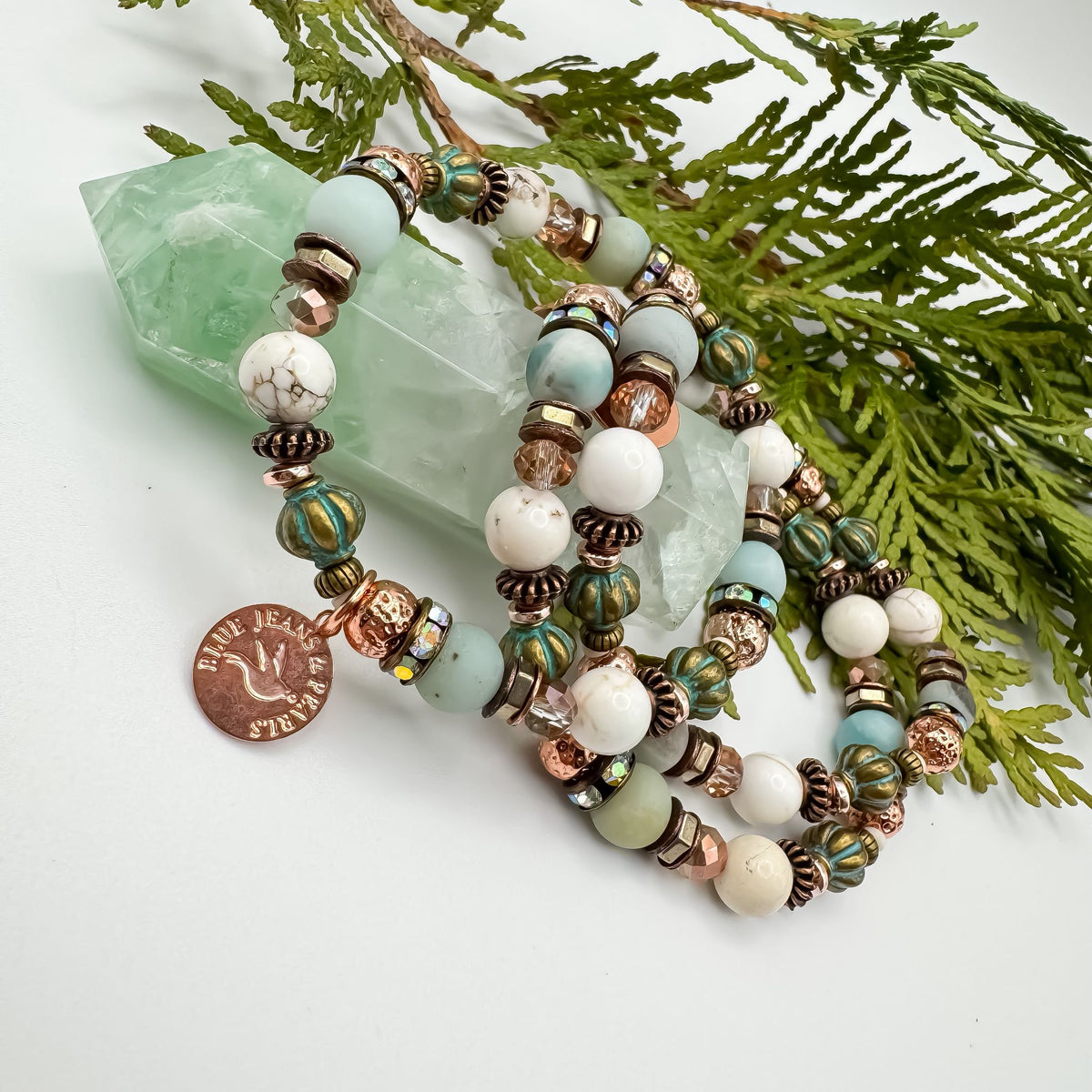 Soft Horizons handmade amazonite, howlite and teal Czech glass bracelet stack draped on green fluorite crystal point with cedar, unique intentional gemstone jewelry by Blue Jeans and Pearls Saskatchewan