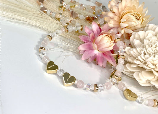 dainty beaded bracelet with rose quartz and clear quartz beads, two heart-shaped, hand-stamped beads