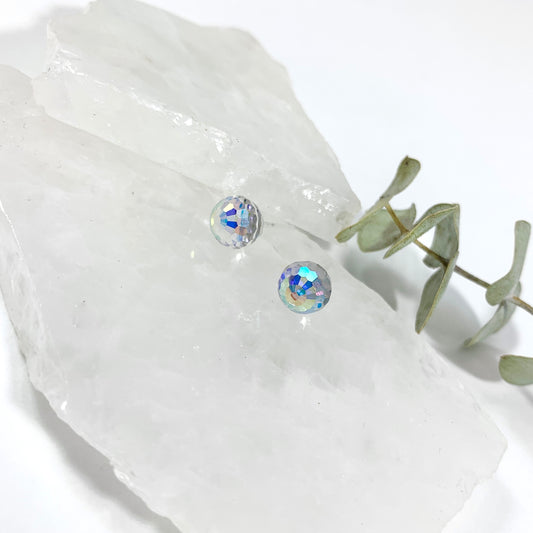 Aurora Borealis disco stud earrings with 8mm faceted Austrian crystal showing rainbow iridescent sparkle on raw white crystal with eucalyptus, sparkly stud earrings for sensitive ears by Blue Jeans and Pearls Saskatchewan