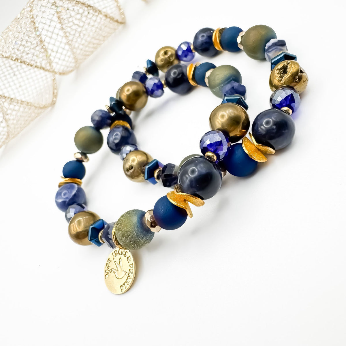 Between Stars Subdued Sparkle handmade bracelet pair featuring sodalite, gold and olive green geode druzy and electroplated hematite with faceted blue glass and brushed gold accents, gold Blue Jeans and Pearls charm, one of a kind moody gemstone jewelry Saskatchewan