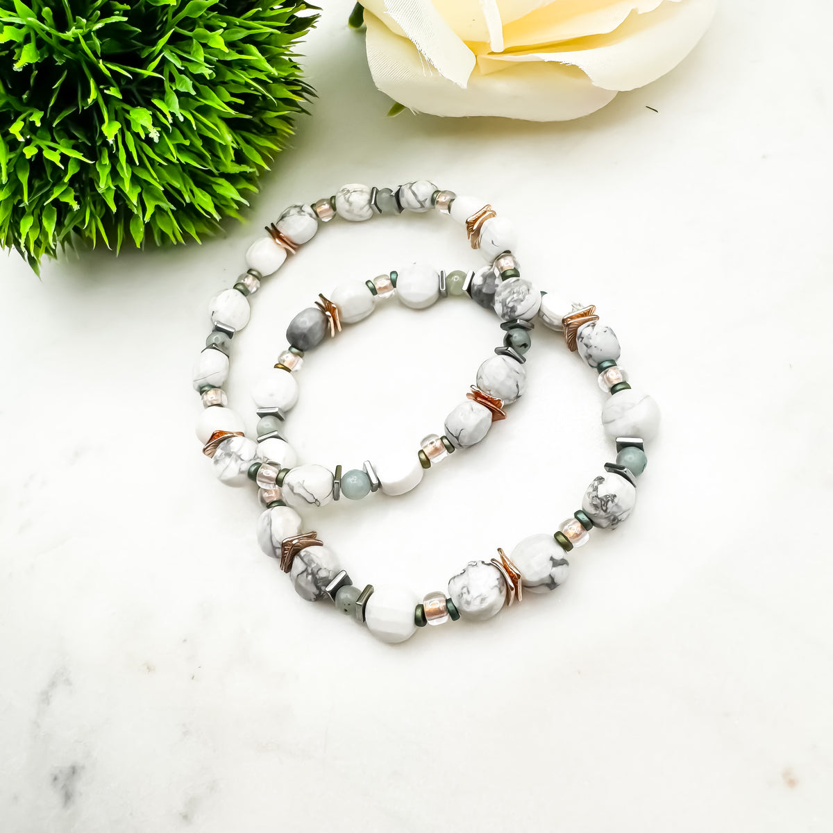 Cool Intentions handmade faceted howlite and lotus jasper bracelet pair with rose gold and silver mixed metal accents on marble surface, anxiety relief and calming gemstone jewelry by Blue Jeans and Pearls Saskatchewan