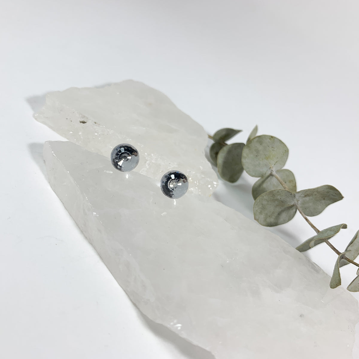 Crystal Clear disco stud earrings with 8mm faceted Austrian crystal on raw white crystal slabs with eucalyptus sprig, sparkly hypoallergenic stud earrings for sensitive ears by Blue Jeans and Pearls Saskatchewan