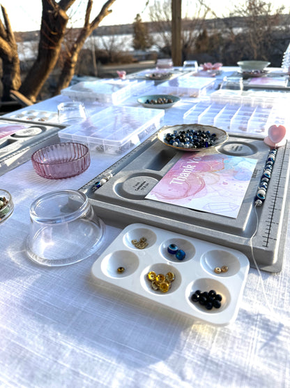 Crystal bracelet making workshop setup with gemstone beads and tools by Blue Jeans and Pearls, Regina Saskatchewan