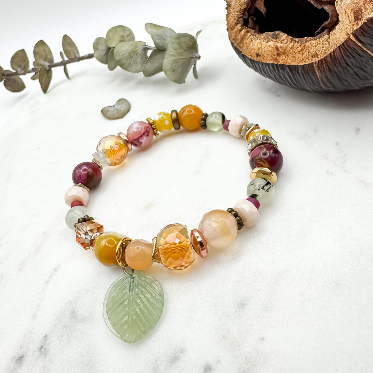 Prairie Sunsets Fuchsia and Firelight handmade fire agate, prehnite and serpentine bracelet with glass leaf charm and Austrian crystal beads on marble styled with eucalyptus, one of a kind nature inspired jewelry by Blue Jeans and Pearls Saskatchewan