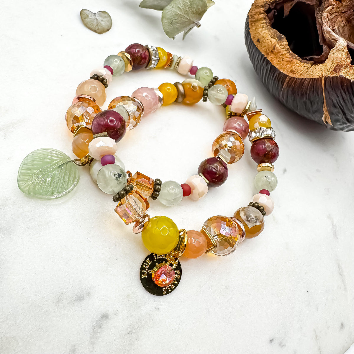 Prairie Sunsets Fuchsia and Firelight handmade prehnite, serpentine and fire agate bracelet duo with glass leaf and gold Blue Jeans and Pearls charm on marble, bold one of a kind Canadian made gemstone jewelry Saskatchewan