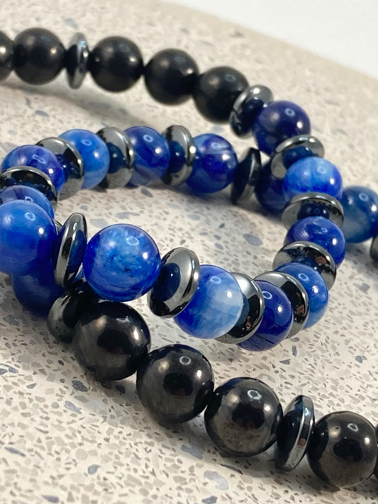 Men's Blue Kyanite, Shungite and Hematite handmade bracelet stack close up with vivid royal blue kyanite 8mm beads, polished black shungite and hematite saucer spacers on terrazzo, men's crystal jewelry by Blue Jeans and Pearls Saskatchewan