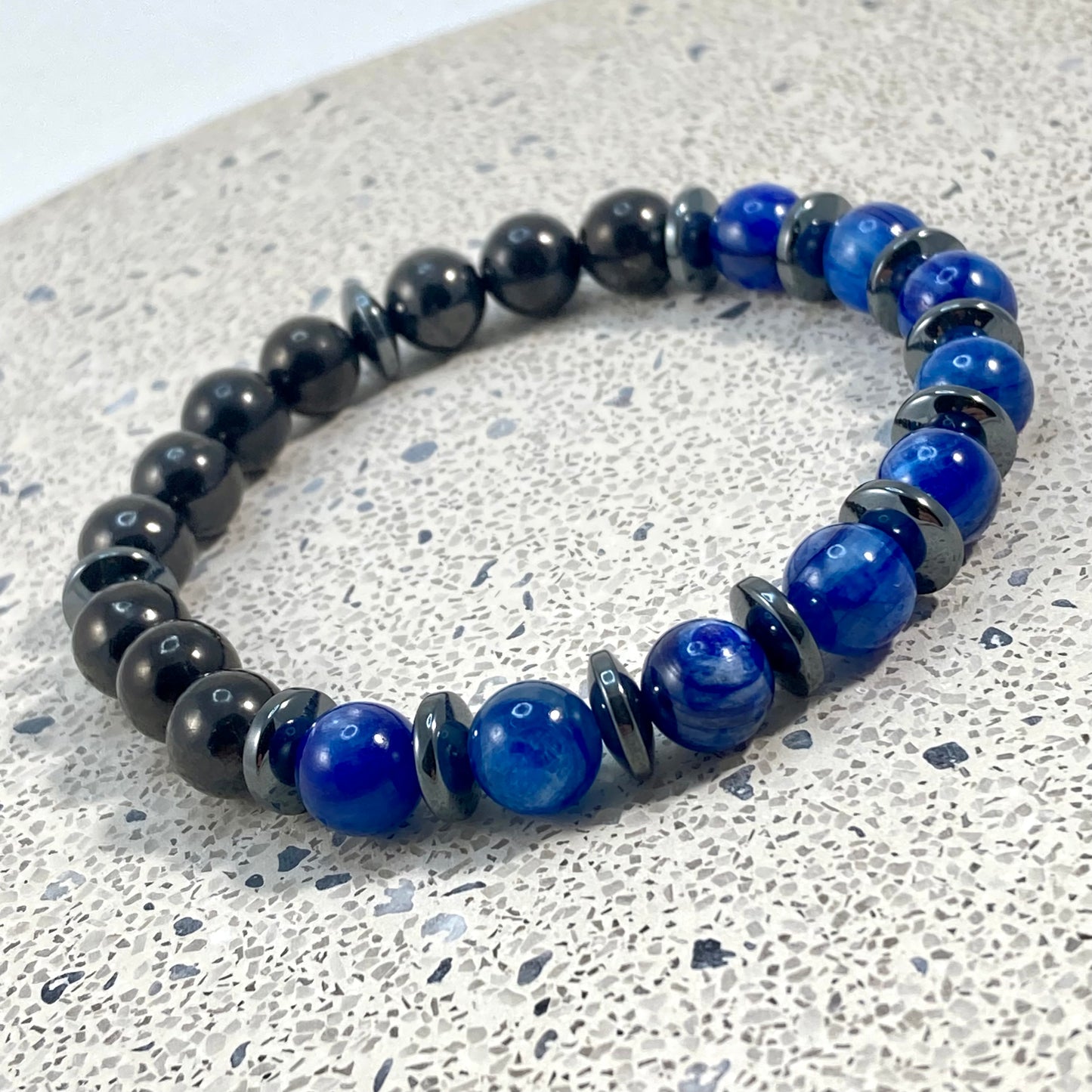 Men's Blue Kyanite, Shungite and Hematite handmade bracelet with royal blue kyanite, polished black shungite beads and hematite saucer spacers on terrazzo, intuitive men's gemstone jewelry handcrafted by Blue Jeans and Pearls Saskatchewan