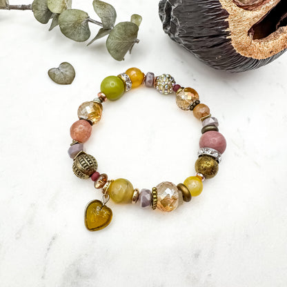 Prairie Sunsets Lime and Lilac Skies handmade prehnite, rhodochrosite and fire agate bracelet with amber glass heart charm and gold metallic accents on marble, unique prairie inspired gemstone jewelry by Blue Jeans and Pearls Saskatchewan