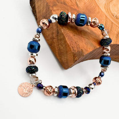 Silver Horizon handmade electroplated hematite, Czech glass and lava stone bracelet with rose gold Blue Jeans and Pearls charm styled on natural wood, mixed metal prairie inspired jewelry Saskatchewan