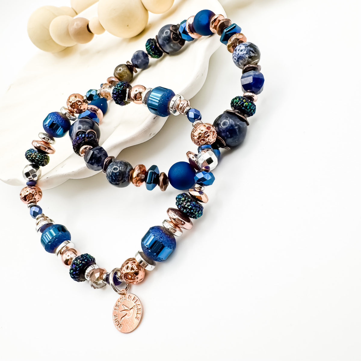 Silver Horizon and Living Skies handmade blue gemstone bracelet stack styled together on white shell display, stackable prairie inspired jewelry by Blue Jeans and Pearls Saskatchewan