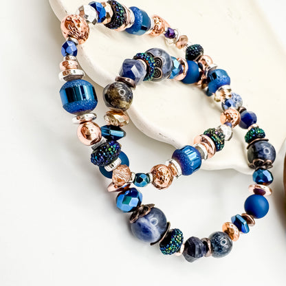 Silver Horizon and Living Skies handmade blue gemstone bracelet pair showing mixed metal and sodalite bead detail on white ceramic display, stackable handmade jewelry by Blue Jeans and Pearls Saskatchewan