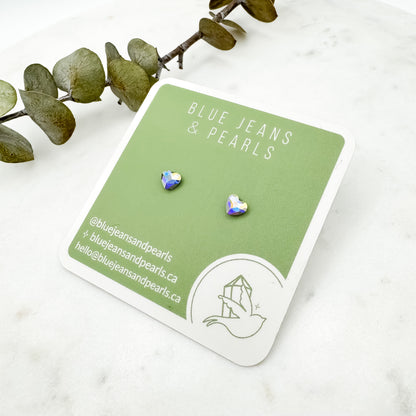 Small Heart Stud earrings in aurora borealis Austrian crystal on a sage green Blue Jeans and Pearls earring card with eucalyptus on marble, metal-free studs for sensitive ears by Blue Jeans and Pearls Saskatchewan