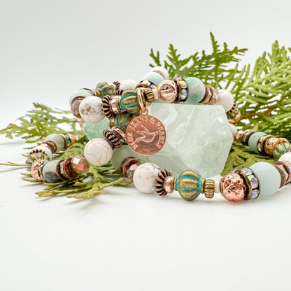 Soft Horizons handmade amazonite and riverstone bracelet stack with rose gold charm styled on green fluorite crystal with cedar branches, one of a kind healing jewelry by Blue Jeans and Pearls Saskatchewan