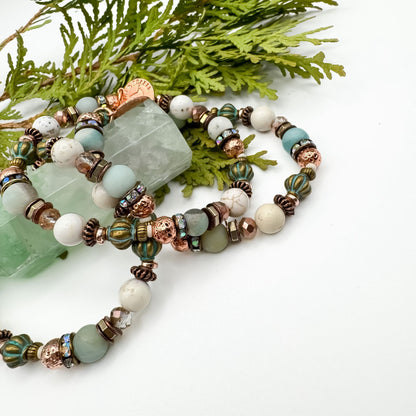 Soft Horizons handmade amazonite, howlite and riverstone bracelet pair with teal Czech glass and copper accents styled on green fluorite crystal tower, unique healing jewelry by Blue Jeans and Pearls Saskatchewan