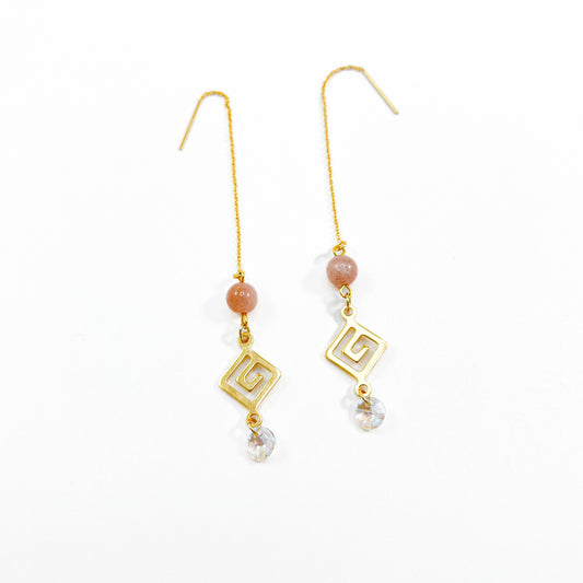 Sunstone Drop Threader earrings with peach sunstone beads, gold spiral Greek key charms and faceted Austrian crystal drops on long gold threader chains, handmade gemstone earrings by Blue Jeans and Pearls Saskatchewan