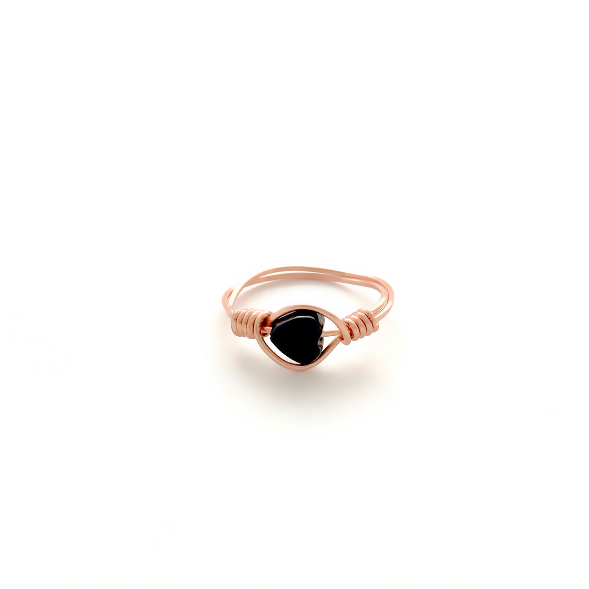 Black Onyx Heart wire-wrapped ring in rose gold finish copper wire with a polished black onyx heart bead and coiled wrap detail on a white background, handmade gemstone heart ring by Blue Jeans and Pearls Saskatchewan